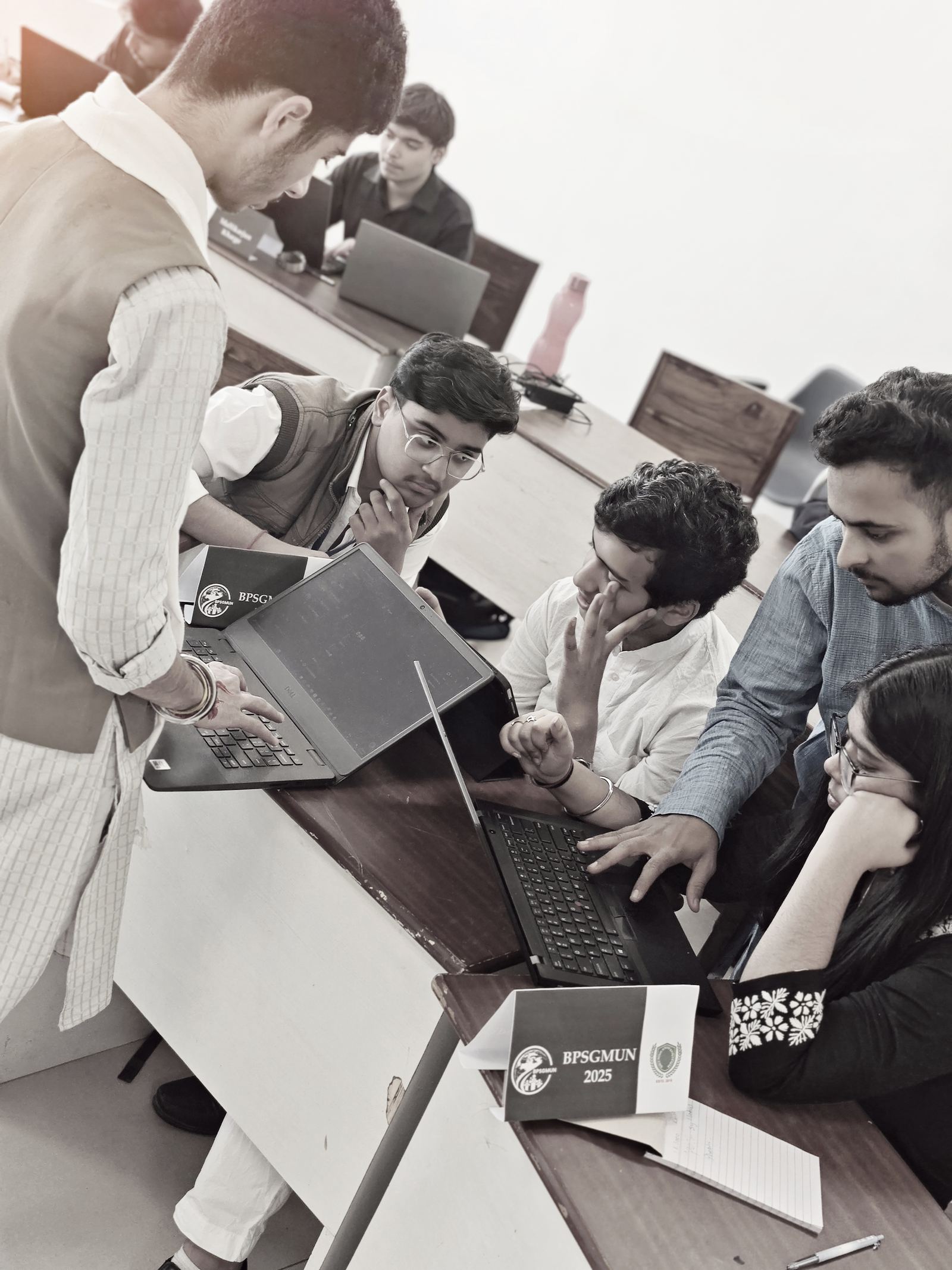 Delegates working together around laptops