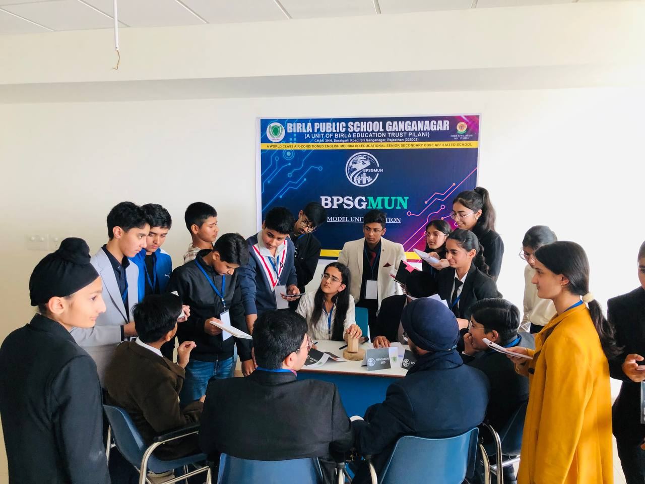 Delegates gathered around the BPSGMUN banner at Birla Public School, Ganganagar